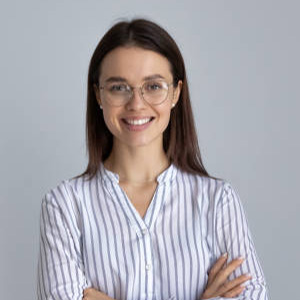 Happy millennial business woman in glasses posing with hands folded isolated on white, looking at camera, smiling. Confident female customer, young student girl, professional head shot portrait